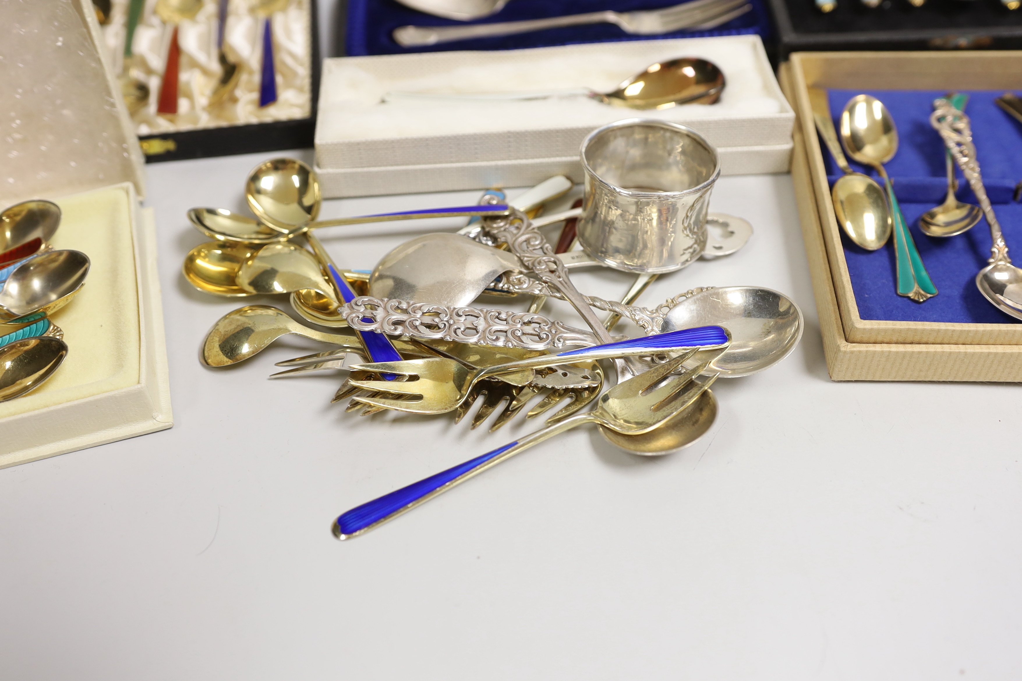 Two sets of eight Norwegian 925S and polychrome enamelled coffee spoons, by David Andersen, one other cased set of six Norwegian 925 and enamelled coffee spoons, a similar spoon and fork, a set of twelve Danish sterling